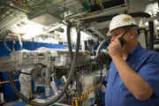 Tom Kohut, Target Experimental Operations Manager, oversees a team of Target area operators, maneuvering a diagnostic handling unit into place inside the National Ignition Facility at the Lawrence Livermore Labs in Livermore, CA on Friday, June 12, 2015.    (photo credit:  National Geographic Channels/Erin Lubin)