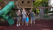 Ron Daniels, John Daniels, Brent Martin and his family in front of the completed treehouse.