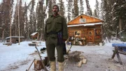 Ray standing outside his cabin.
