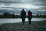 Edna and Heimo walks by the river.