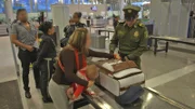 BOGOTA, Colombia - A woman is stopped with a suspicious document.