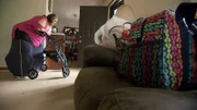 Tracey wheels herself through her house.