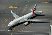 Dubai Airport, UAE: Emirates plane taxing on runway.