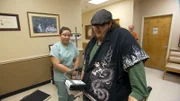 Justin gets weighed in at a doctor consultation.
