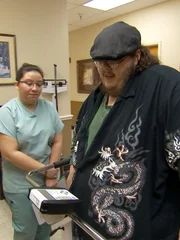 Justin gets weighed in at a doctor consultation.