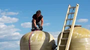 Gabe sourcing water tanks at junkyard.