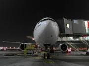 Dubai Internatioanl Airport - Plane boarding at night.