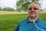 Mary standing near a field.