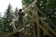 Builders Dillon and Ryan are installing new roof rafters to the extended part of the cabin, in the Bullpen cabin build, at Clearwater Lake, Maine, as seen on DIY Network's Maine Cabin Masters.