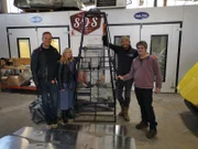 Tim and Fuzz pose with Susan Yarranton and Ifan Davies beside the Cannon chassis at the workshop.