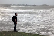 Diu, India: RJ standing by the sea. The sea has always been a big part of Diu. Diu has seen its fair share of natural sea disasters and wars that have taken place at sea. The main occupation of the locals of Diu is fishing, a dangerous trade subjected to the state of the sea.