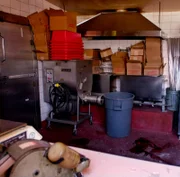 Dies ist der Schauplatz in einer Wurstfabrik in San Leandro, Kalifornien, wo laut Polizei von San Leandro drei staatliche Fleischkontrolleure ermordet wurden. Im Vordergrund ist zerbrochenes Glas auf dem Tresen zu sehen, im Hintergrund ist vermutlich Blut auf dem Boden zu sehen.