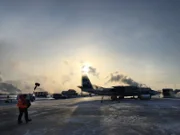 Behind the scenes: Filming: Soundman approaches plane on Yakutsk runway.