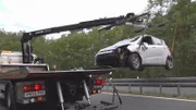 Removing a crashed car from the highway.