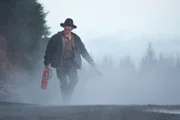 Matt Brown walks with a fire extinguisher.