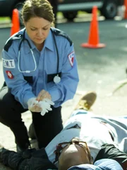 Paramedics and Faustos Santos helping a wounded Chester.