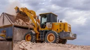 The Blacklighters' loader loads dirt into Opalzilla's hopper