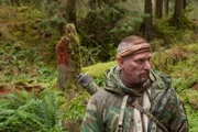 USA, Washington, Olympic National Forest,  Dave Canterbury walking through Pacific Northwest rainforest during Dual Survivor filming