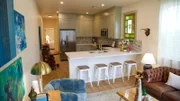 After shot of the open concept living room and kitchen at the Astrology house. Showing the massive kitchen with all the appliances, as seen on Bargain Block New Orleans, Season 1.