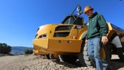 Hunter Hoffman walking past his rock truck.