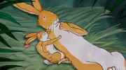 Der große Hase erzählt dem kleinen Hasen, dass Regenbögen nur sehr selten am Himmel erscheinen und nie lange bleiben.