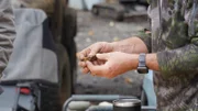Man holding a gold nugget.