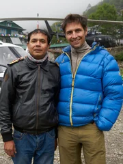 Manang Air Pilot Hira Dahan and Lorenz Nufer in front of Manang Air B3 helicopter. Lukla airport helipad, Nepal.