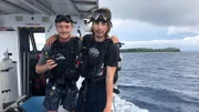 L-R: Sam and Parker posing on the boat in diving gear