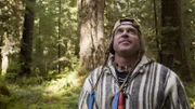 USA, Washington, Olympic National Forest, Cody Lundinwalking through Pacific Northwest rainforest during Dual Survivor filming