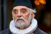 Alessandro Bressanello as the Priest