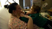Penny playing with her son in bed.