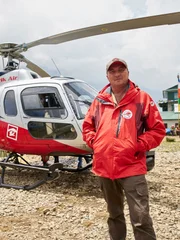 Simrik Air pilot Jason Laing with Simrik Air B3 helicopter at Lukla helipad, Nepal.