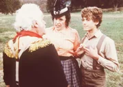 Harriet Oleson (Katherine MacGregor, M.) und ihr Sohn Willie (Jonathan Gilbert, r.) hören interessiert zu, als der große Gambini (Jack Kruschen, l.) ihnen vom Zirkus erzählt.