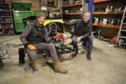 Presenter's Tim & Fuzz sitting in front of the dismantled Austin 7.