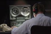 RE-ENACTMENT STILL:  Audio technician listens to the CVR.   (Photo Credit: © Cineflix 2009)  . MD9 PvsP_025.tif