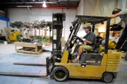 Jose driving forklift in warehouse.