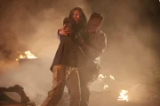A bystander tries to assist Ulrika Bjorkstam  (played by Sarah Wilson), one of the more than forty people who are injured when a Learjet 45 crashes into a busy intersection in Mexico City.
