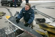 REENACTMENT - NTSB-Ermittler Tom Haueter (gespielt von Christian Lloyd) entdeckt Farbe, die bei einem tödlichen Flugzeugzusammenstoß am Quincy Regional Airport auf ein Wrackteil übertragen wurde.