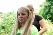 Janne hat sehr langes Haar. Da kann es im Sommer ganz schön warm werden! Gut, dass Jannes Mutter ihr beim Frisieren hilft.
