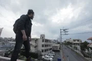 ĘUechi, Okinawa: RJ Standing on rooftop of Crown Hotel, overlooking the street below.