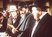 Der Verleger Mr. Callihan (M. Emmet Walsh, r.) überreicht Mr. Edwards (Victor French, M.) die persönlichen Sachen seines vorstorbenen Sohnes.