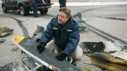 REENACTMENT - Ein Flugunfallermittler (gespielt von einem Darsteller im Hintergrund) untersucht die Kratzer auf der Tragfläche des Atlantic Airways Fluges 670. (Bildnachweis: Cineflix/Darren Goldstein)