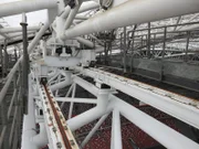 Shot of the machinery on the roof of Singapore Stadium with the image of the stands below.