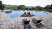 This Franklin, TN backyard has completely transformed and now has beautiful landscaping and a seating area as seen on Pool Kings. AFTER 1 (exterior, after)