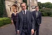 ONE ADAM DALGLIESH, SCOTLAND YARD, "Im Saal der Möder - Teil 1", am Mittwoch um 21:45 Uhr. Adam Dalgliesh (Bertie Carvel, Mitte) und Miles Kynaston (David Pearson, r.).  v.r.n.l. Kate Miskin (Carlyss Peer), Adam Dalgliesh (Bertie Carvel) und Daniel Tarrant (Alistair Brammer).
