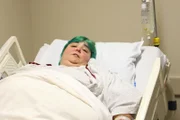 Paula laying down on the hospital bed.