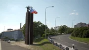 In einer Haarnadelkurve in Prag lauern die Attentäter Heydrich auf und schießen auf ihn.