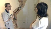 Marcel zeigt seiner Frau Manuela einen riesigen Riss in der Mauer