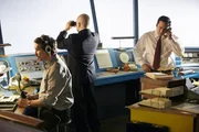 REENACTMENT - The Tenerife Controller (played by Rodrigo Fernandez-Stoll) is on the phone and the Junior Investigator (played by background performer Marcelo Pinero) looks out the tower through binoculars. (Photo Credit: Cineflex/Ian Watson)