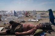 Brantford, Ontario, Canada - After pilot Jimmy Leeward's accident at the 2011 Reno Air Race, spectators at the event try to re-orient themselves, among the wreckage. 10 people on the ground are dead, making this the fourth deadliest airshow disaster in US history.